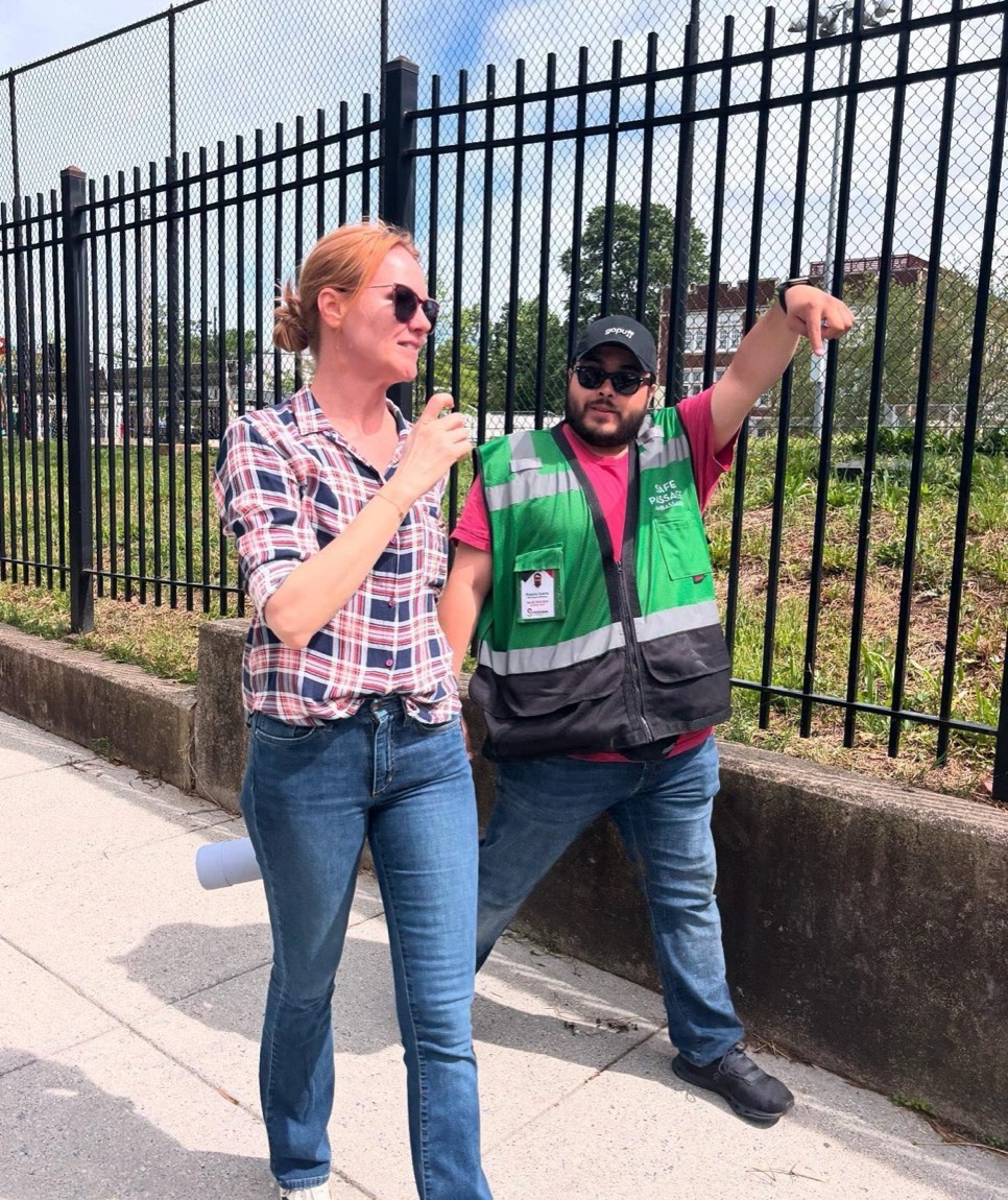 Christine Miller in the neighborhood with a District worker